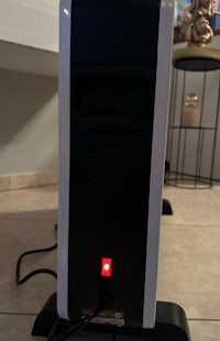 a black and white computer with a red light on it